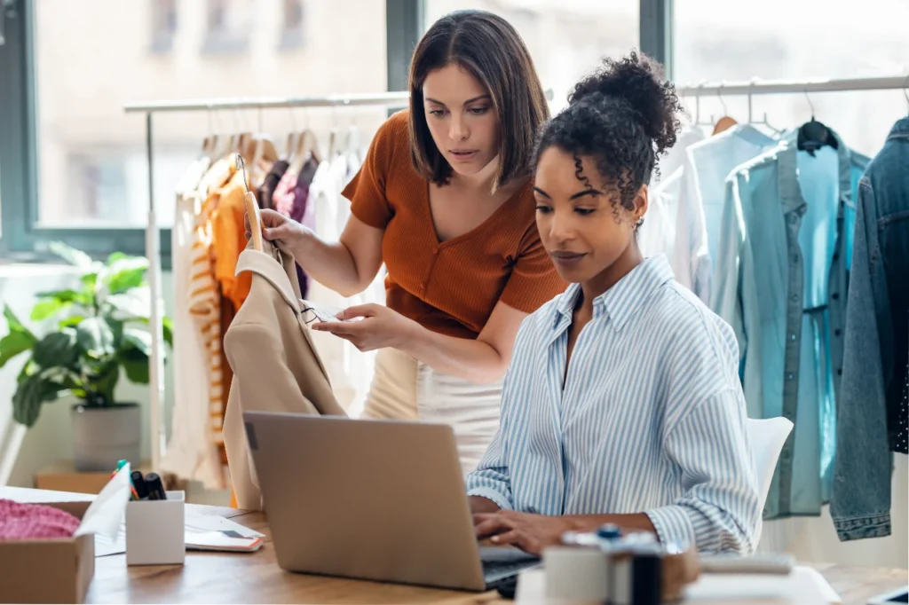 two female designers working on a visual line presentation at an apparel company