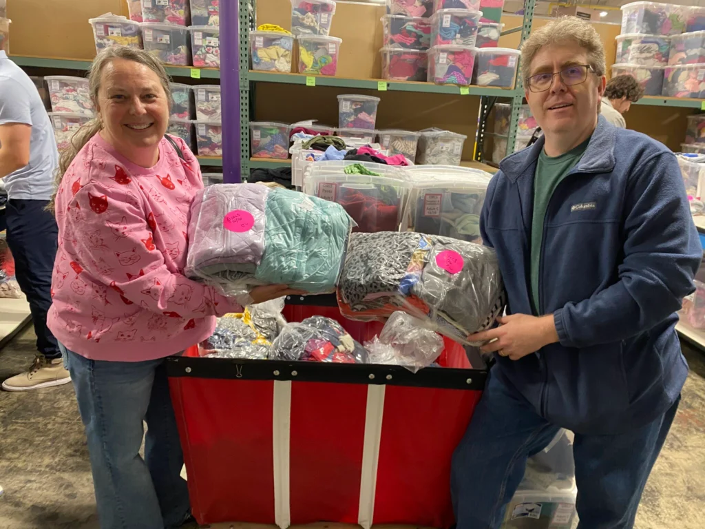 VibeIQ team members helping sort and create outfits for kids at Cradles to Crayons in Newton, MA